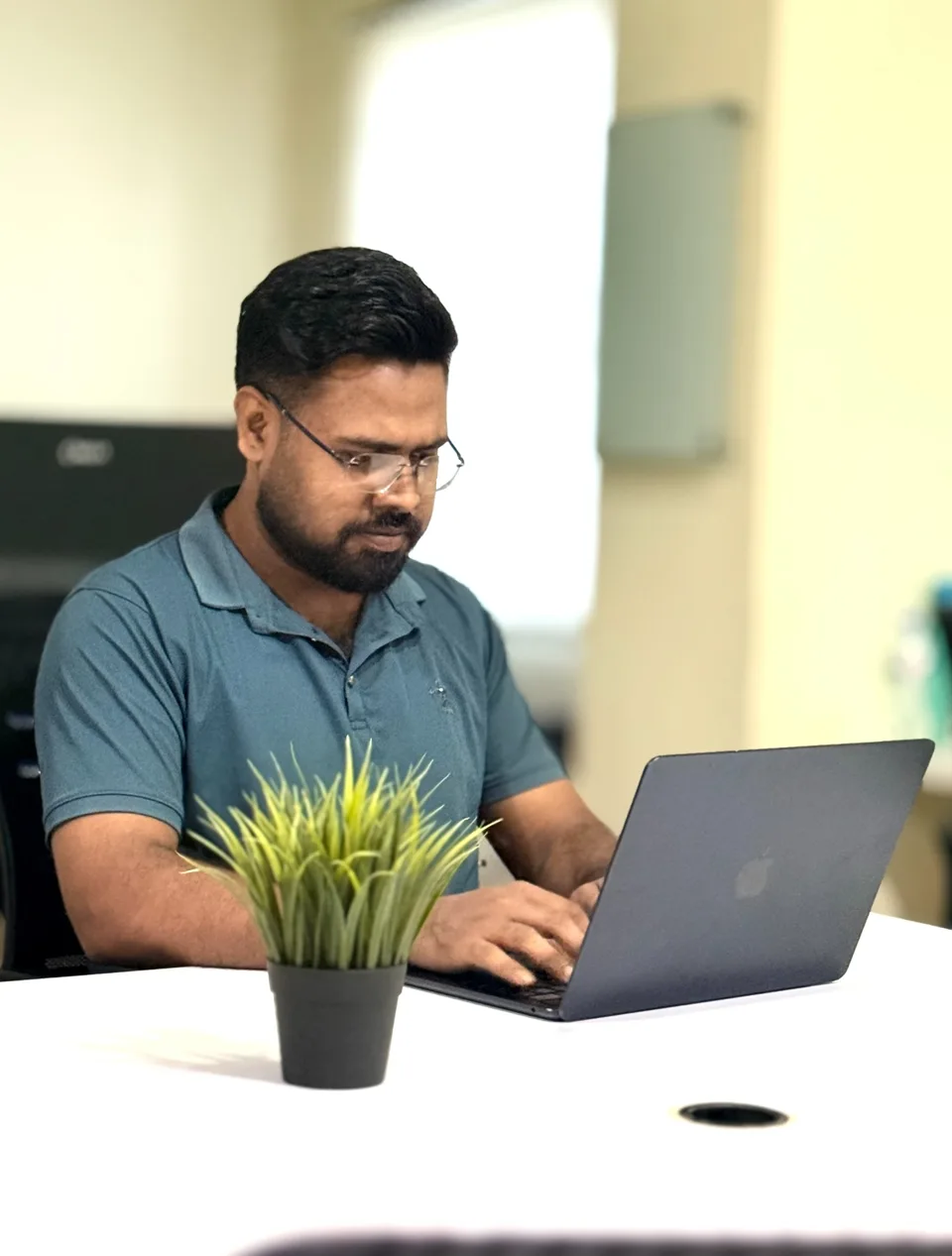 Jibon working at an office desk