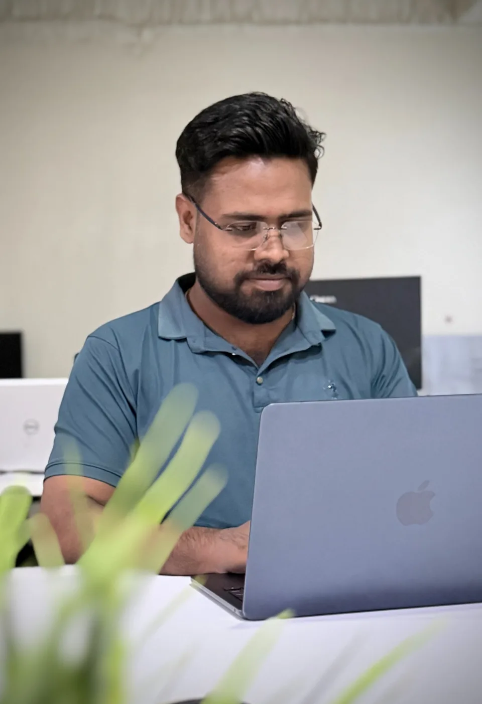 Jibon reviewing work on a laptop